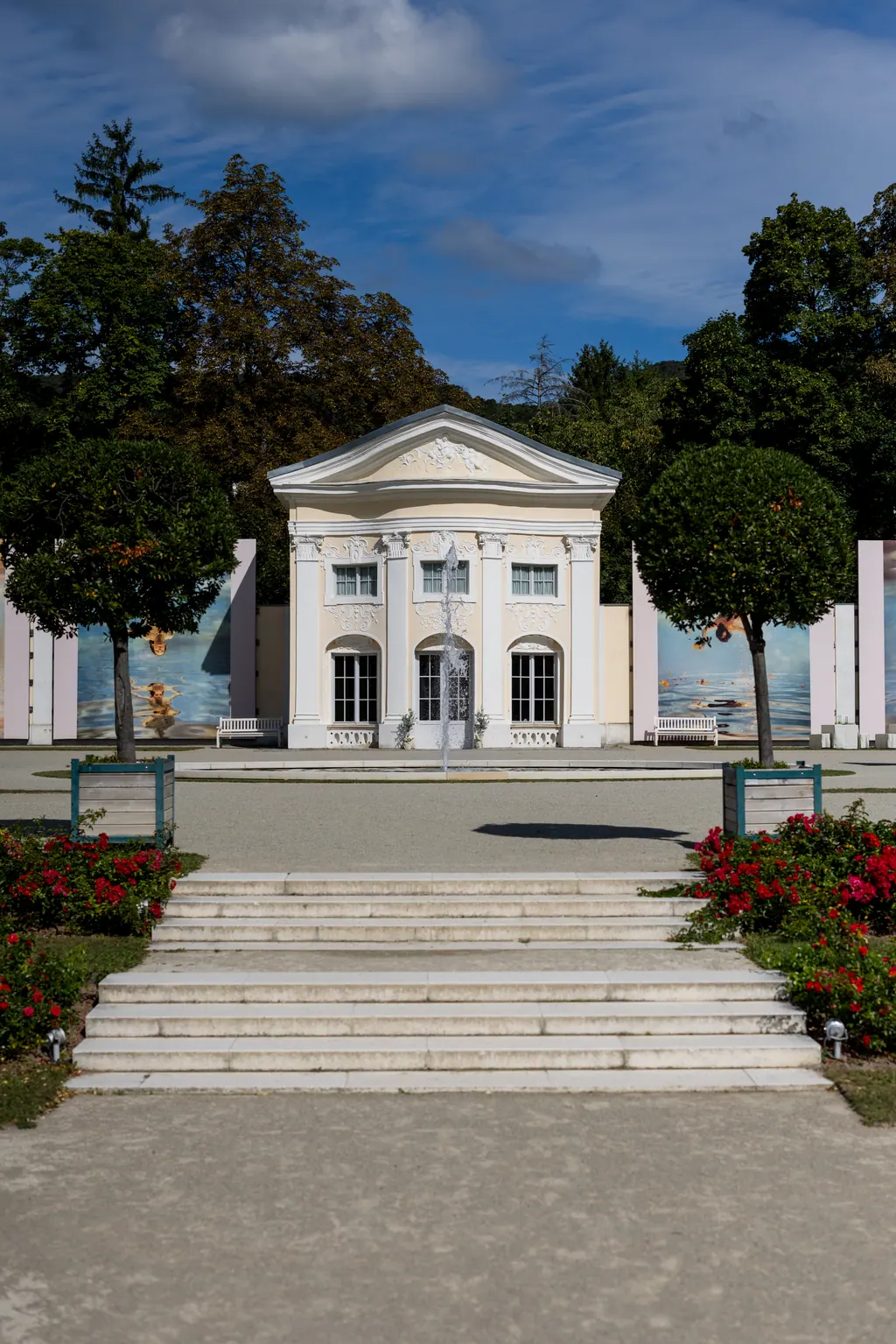 Barocke Orangerie im Rosarium mit Freitreppe, Rosenbeeten und blauem Sommerhimmel